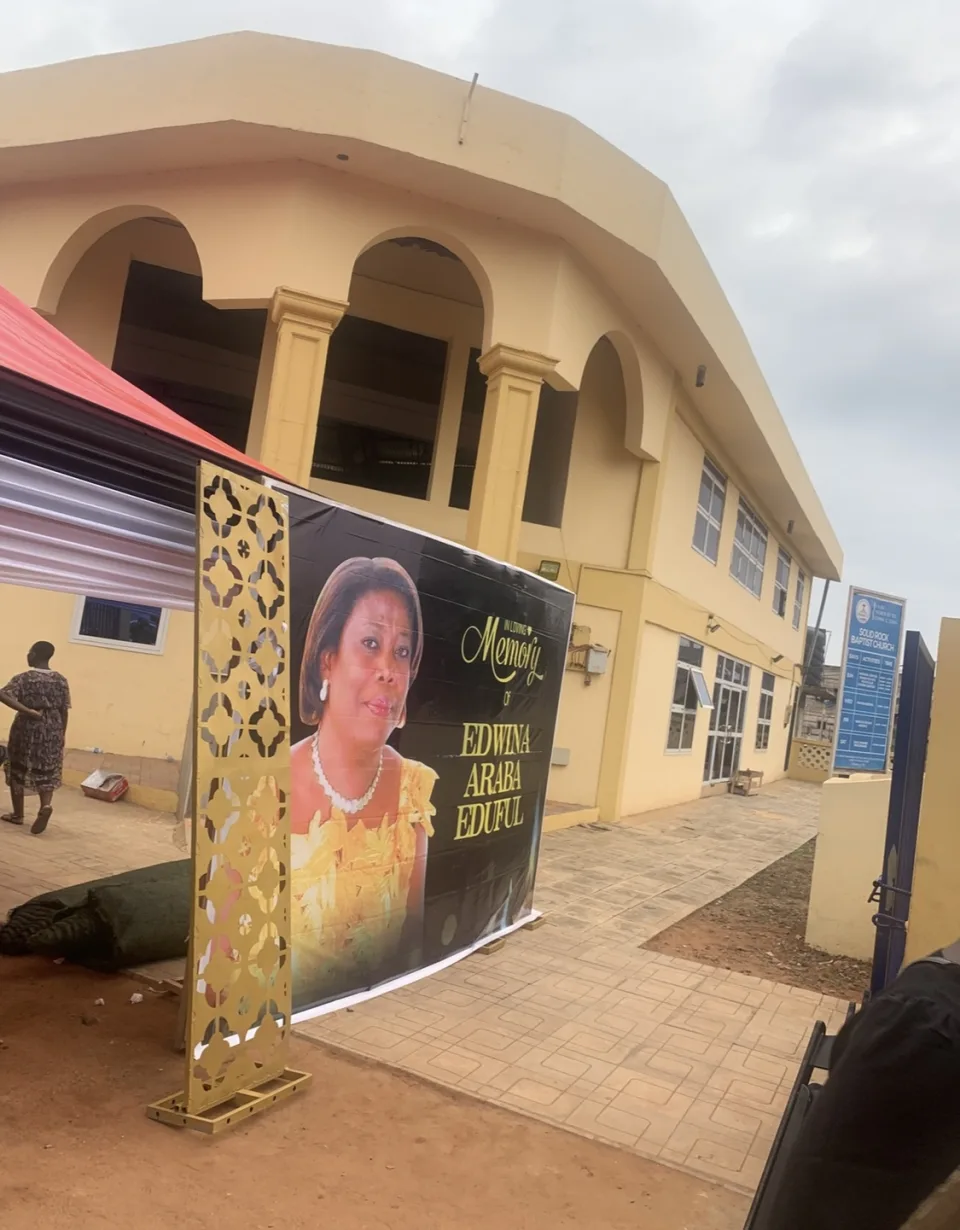 Funeral venue entrance with an Edwina Araba Eduful memorial display in Tema