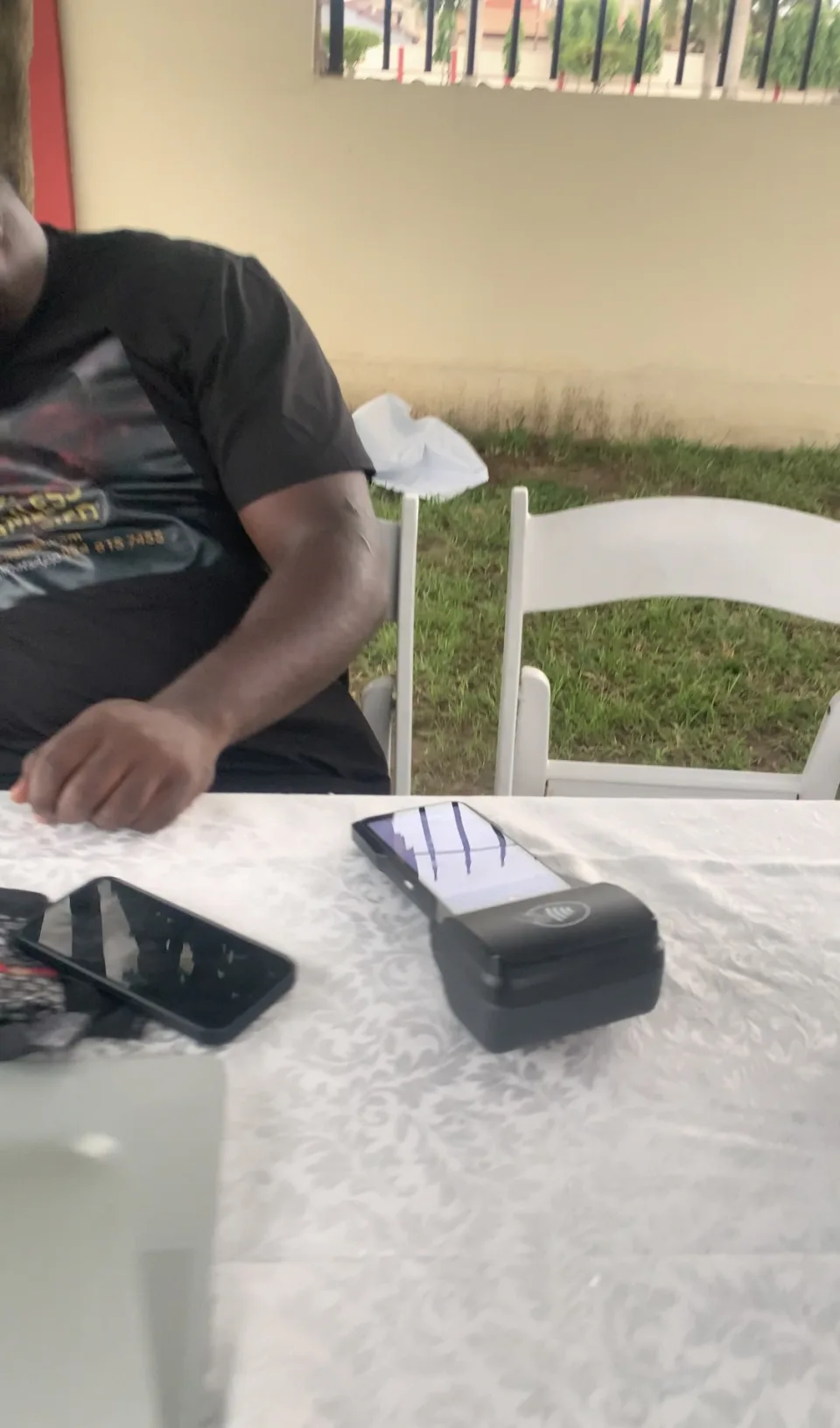 Mobile devices and receipt printer at the Geoffrey Musey funeral contribution desk